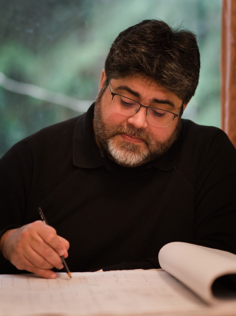 A formal headshot of Liova Bueno. It was taken on his wedding day, so he's looking pretty happy.